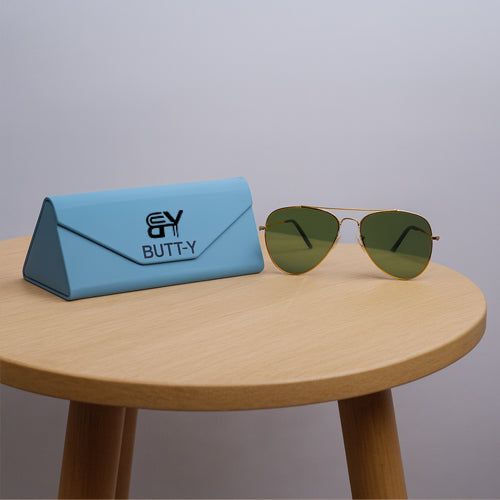 Sunglasses with a blue case on a wooden table against a gray background