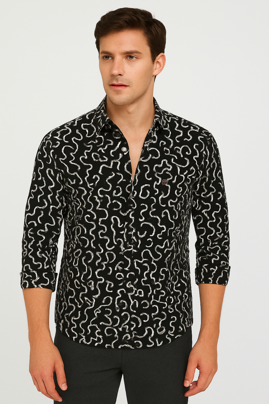 Man wearing a black patterned shirt on a gray background