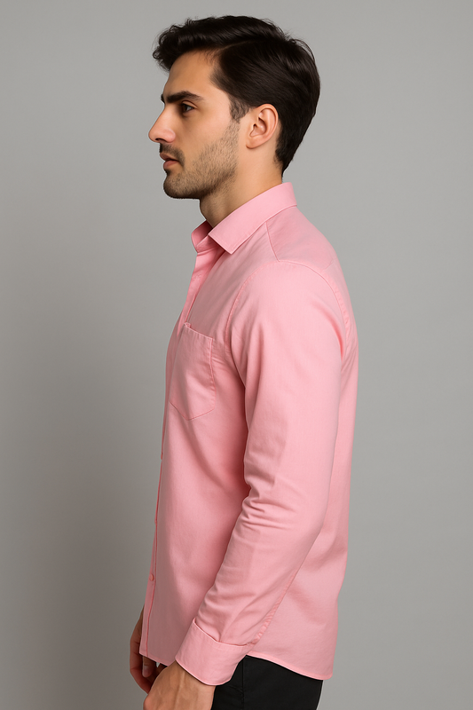 Man wearing a pink shirt against a gray background