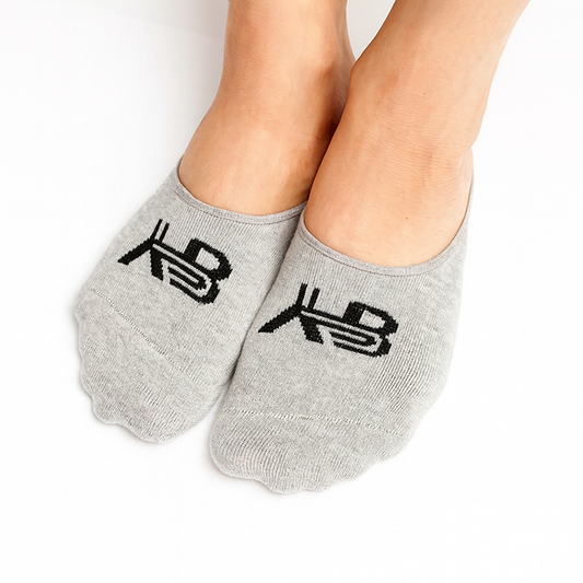 Gray socks with black logo worn by a person on a white background
