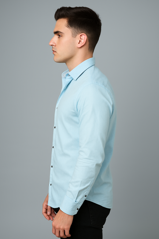 Man wearing a light blue shirt against a gray background