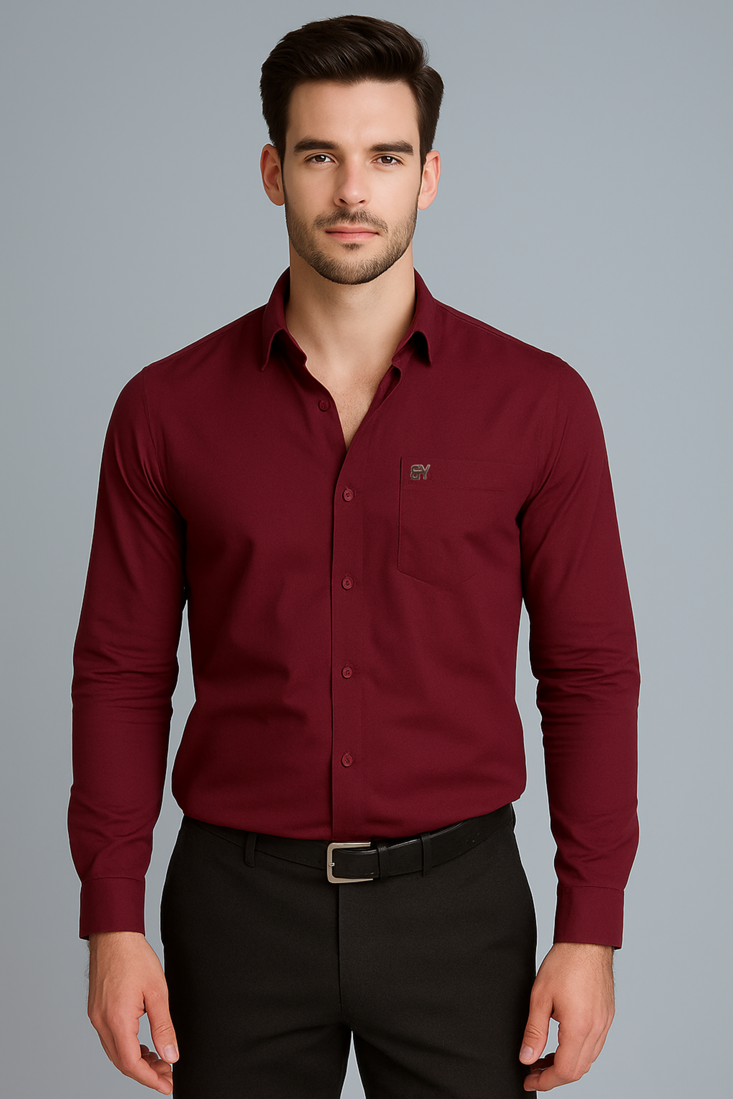 Man wearing a burgundy dress shirt and black pants on a gray background