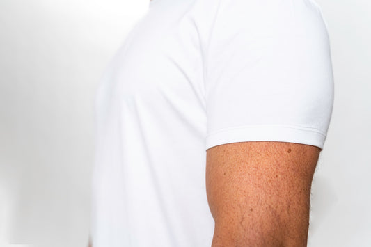 a person's leg with a white shirt and brown pants