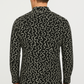 Man wearing a black patterned shirt on a white background