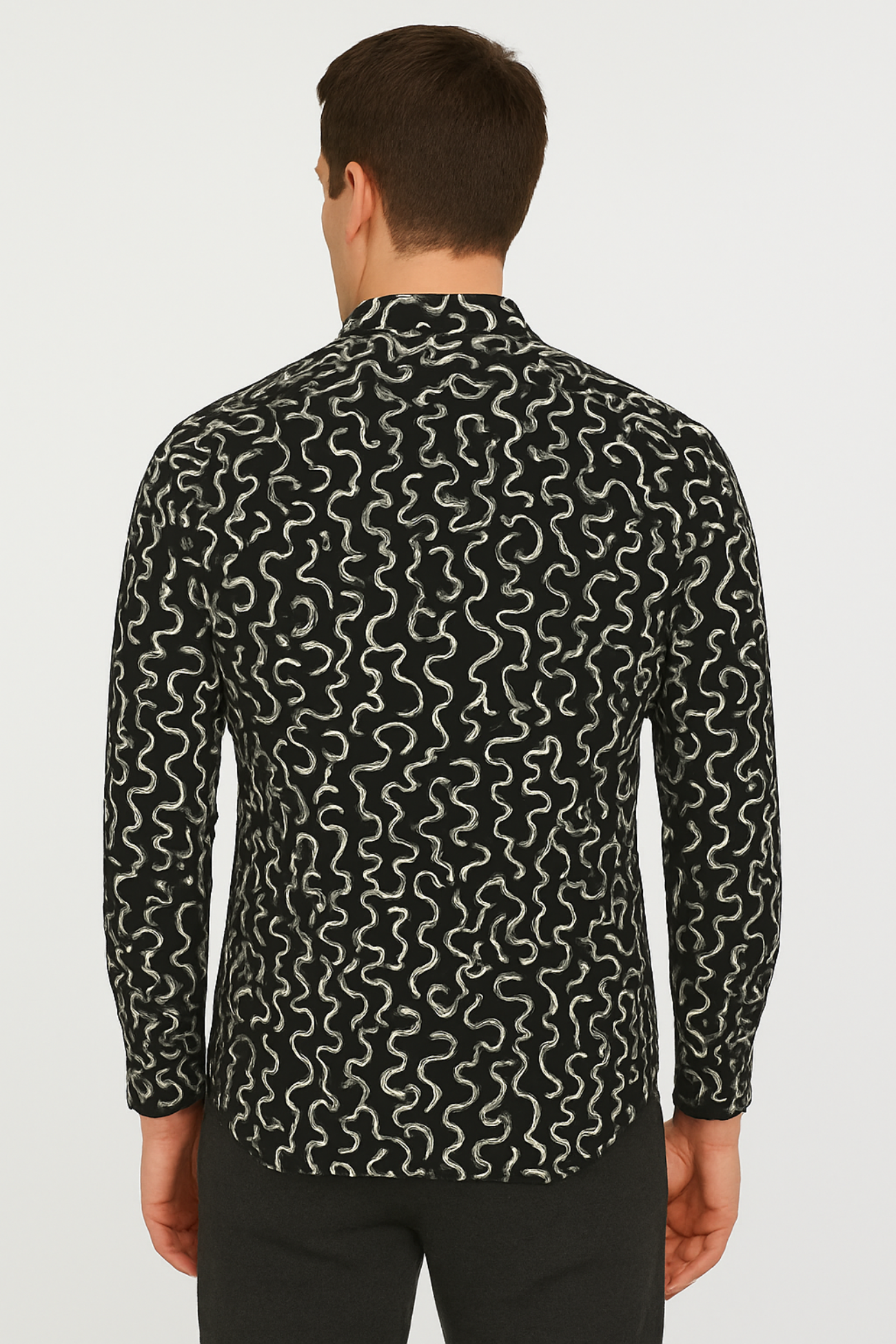 Man wearing a black patterned shirt on a white background