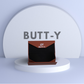 Product packaging with 'GY BUTT-Y' branding on a white platform with a light gray background.