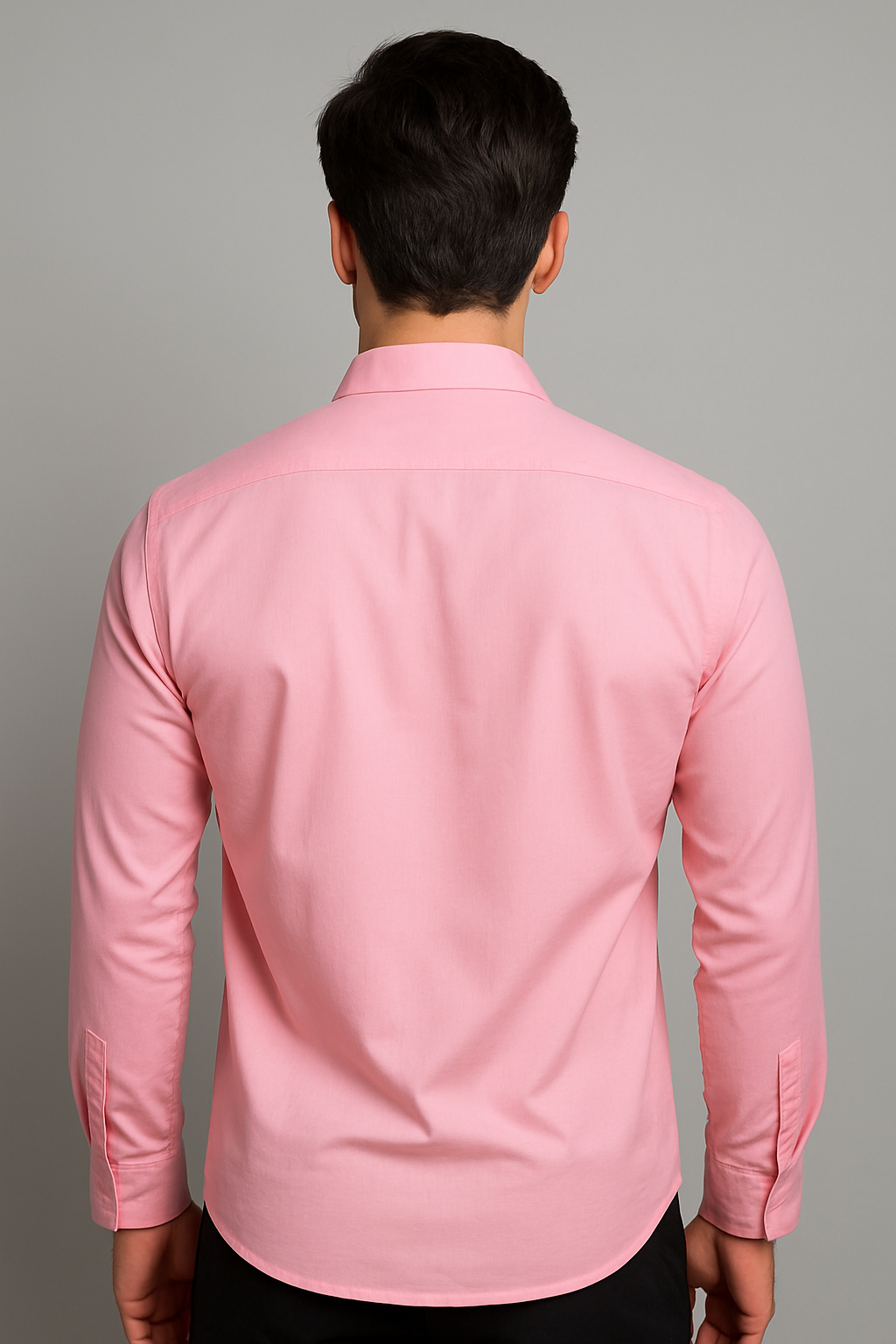 Person wearing a pink shirt against a gray background