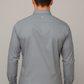 Man wearing a gray dress shirt against a plain background