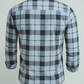 Plaid shirt with rolled-up sleeves on a light gray background
