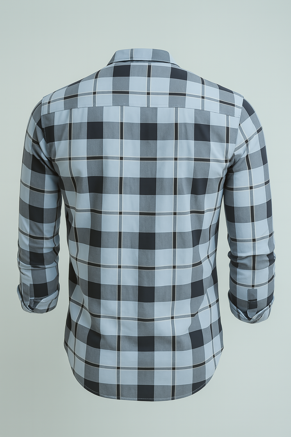 Plaid shirt with rolled-up sleeves on a light gray background