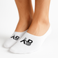 White socks with a logo worn by a person on a light gray background
