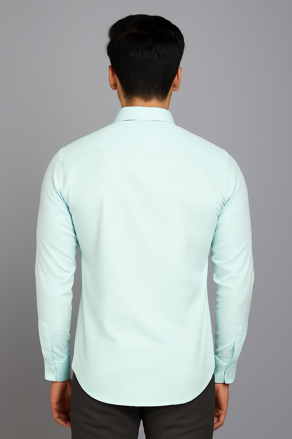 Person wearing a light green shirt against a gray background