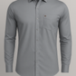 Gray dress shirt with a pocket on a light gray background