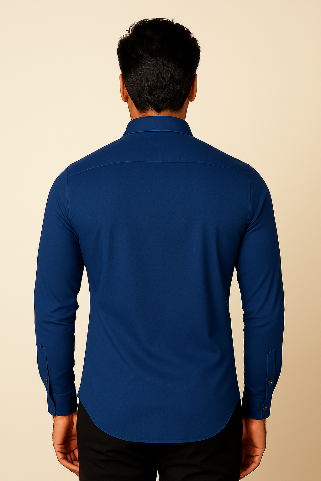 Man wearing a blue shirt against a beige background