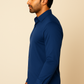Man wearing a blue shirt against a beige background