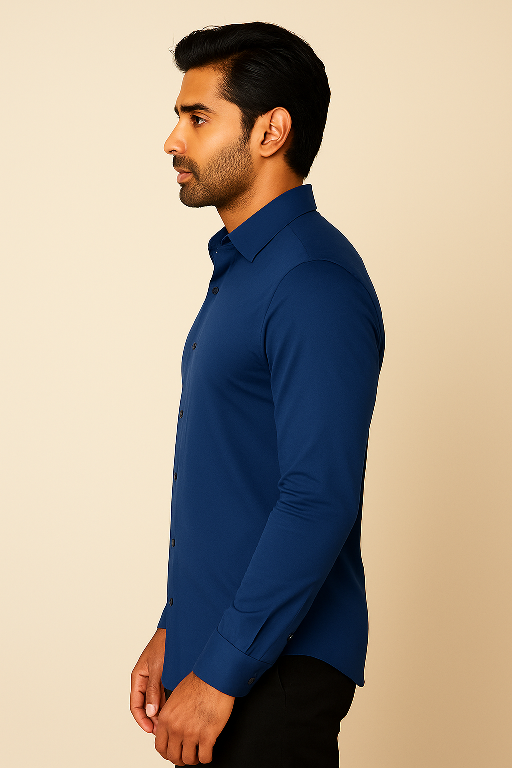Man wearing a blue shirt against a beige background
