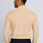 Man wearing a beige long-sleeve shirt against a plain background