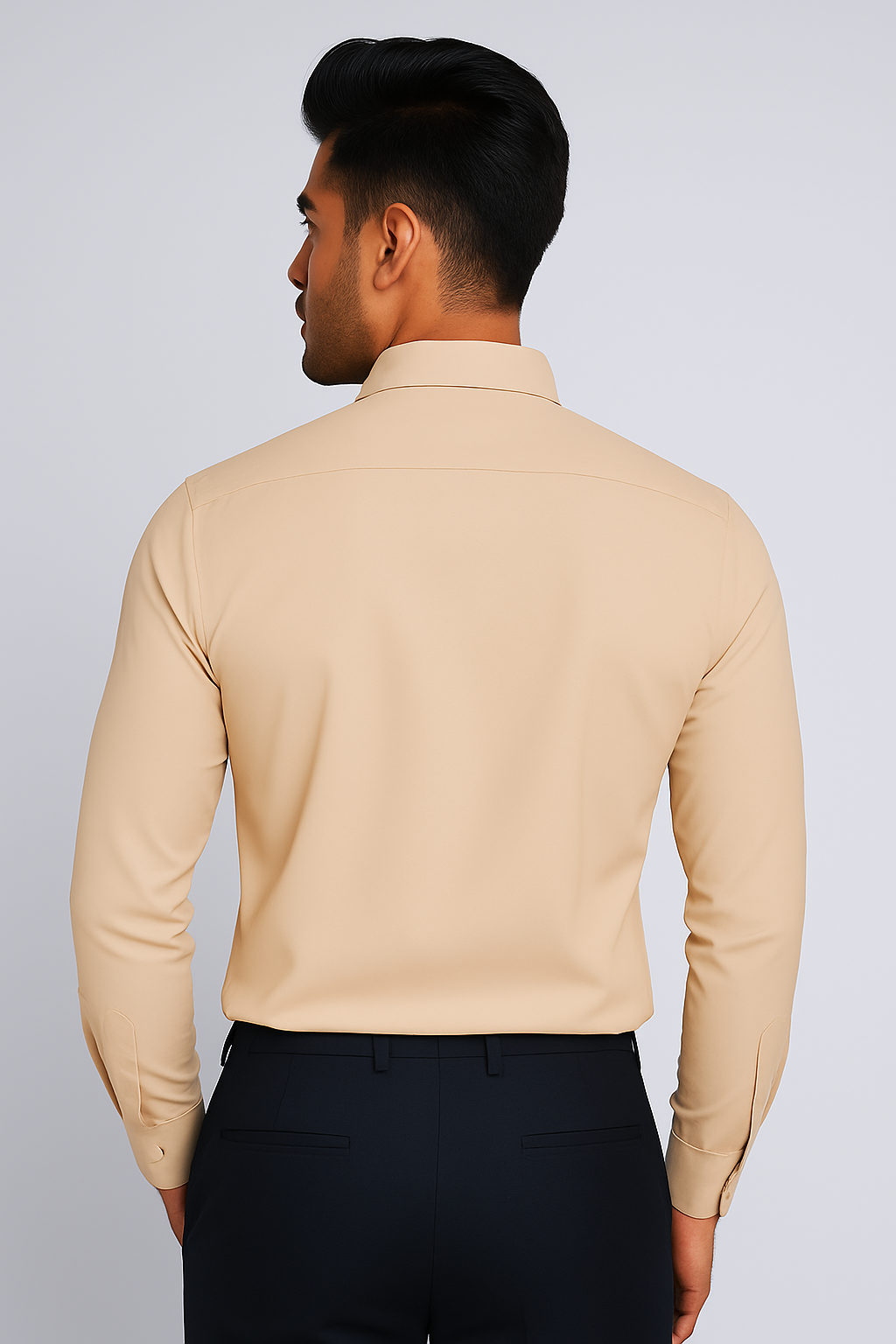 Man wearing a beige long-sleeve shirt against a plain background