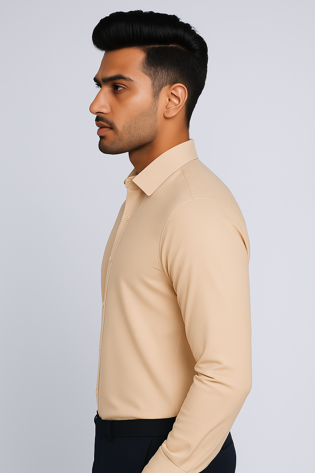 Man wearing a beige long-sleeve shirt against a light gray background
