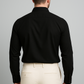 Man wearing a black shirt and beige pants against a gray background