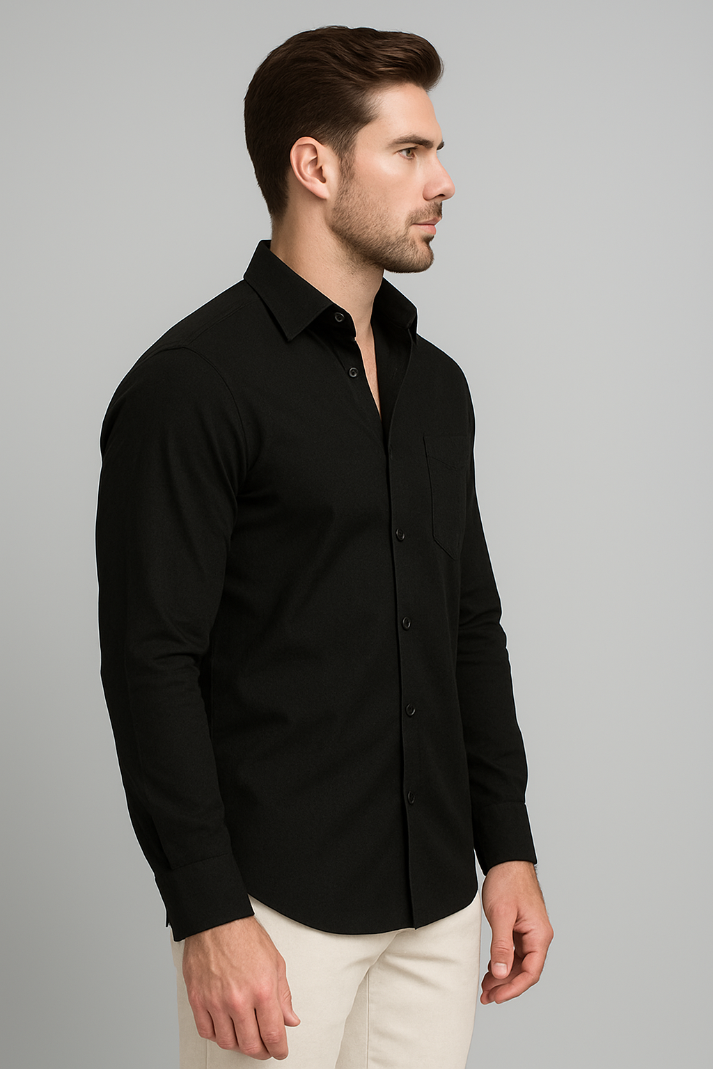 Man wearing a black shirt against a gray background