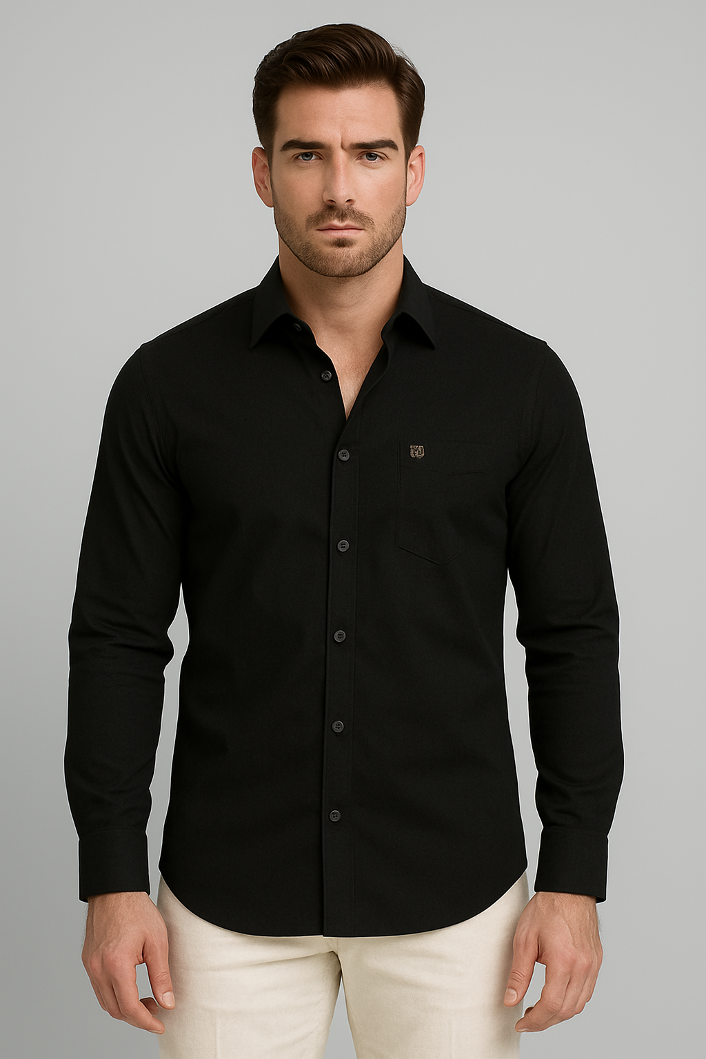Man wearing a black button-up shirt against a gray background