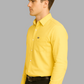 Man wearing a yellow shirt and black pants on a gray background