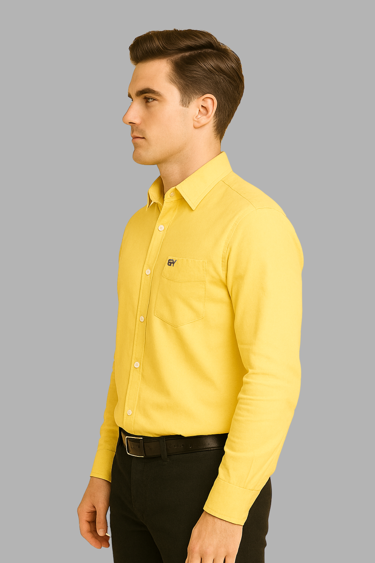 Man wearing a yellow shirt and black pants on a gray background