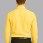 Man wearing a yellow shirt and black pants on a gray background