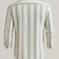 Striped shirt with long sleeves on a light gray background