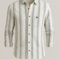 Striped shirt with a brand logo on a light gray background