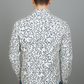 Person wearing a white shirt with black abstract pattern on a gray background